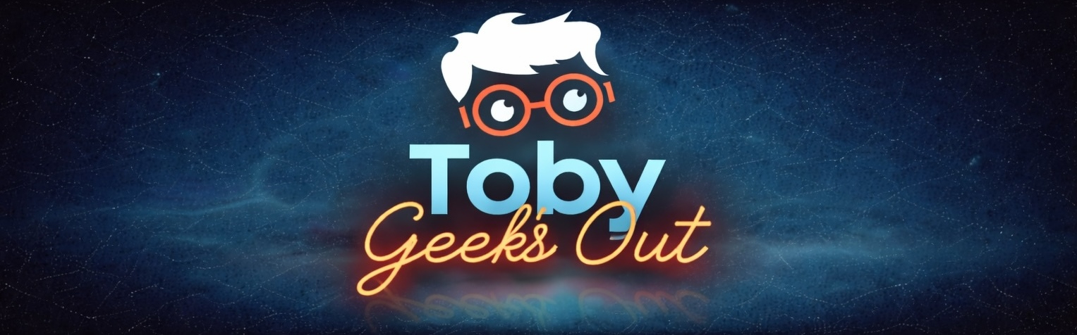 Auto-generated description: A stylized graphic with the text Toby Geeks Out featuring a cartoon of a face with glasses and spiky hair.